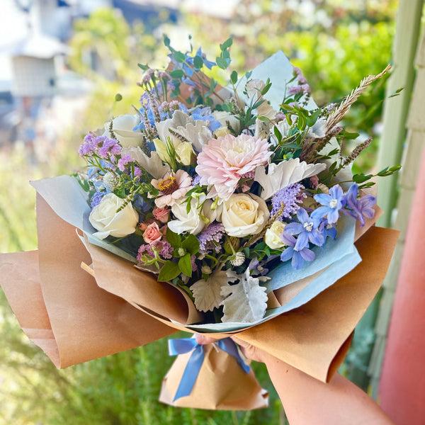 Soft and Dreamy Lush Bouquet featuring delphinium, statice, zinnias, dahlias, roses and more. 